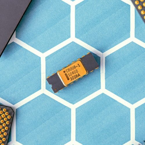 Close-up of various microprocessor chips on a blue hexagonal patterned surface, highlighting electronic technology.